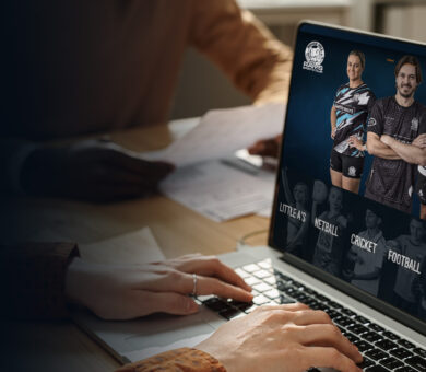 Laptop opened up to a website, within an office environment